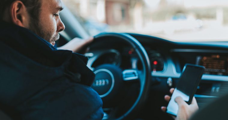 Man driving distracted on phone