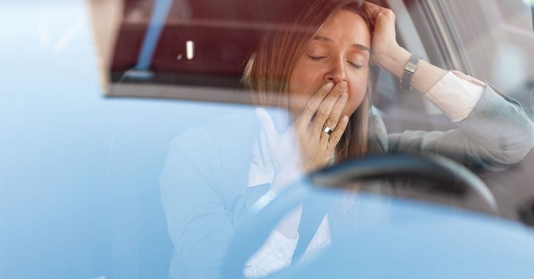 Woman yawning while driving